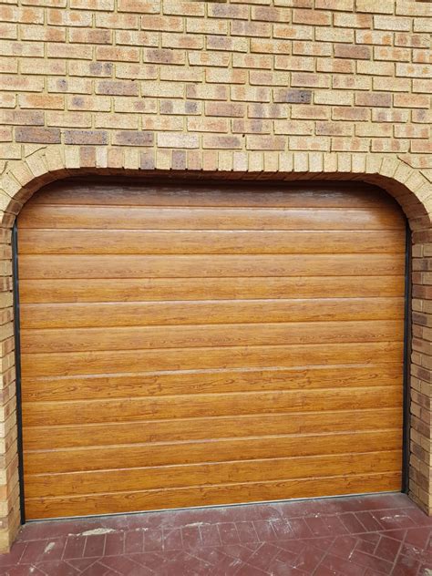 Single Golden Oak Slatted Aluzinc Garage Door Nu Ray Doors