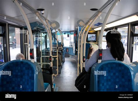 Interior Of Public Transport Single Deck Bus And Passengers Seated Inside