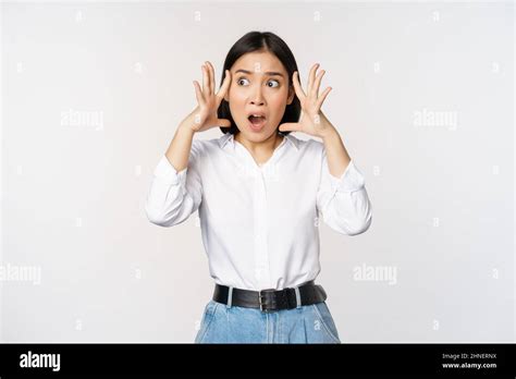 Image Of Shocked Anxious Asian Woman In Panic Holding Hands On Head