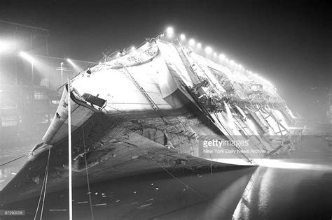 The S.S. Normandie a French ocean liner, lies on its side. The ship ...