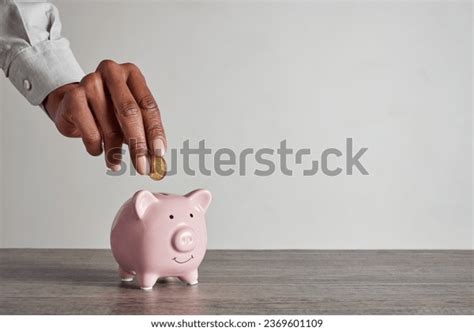 Black Person Adding Coin Piggy Bank Royalty Free Images Stock