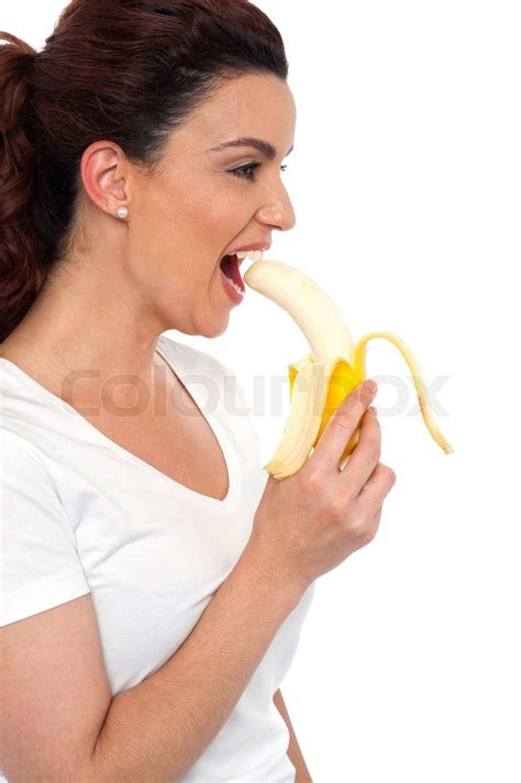 Side View Of Brunette Women Eating Banana Stock Image Colourbox