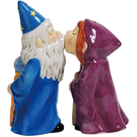 Two Ceramic Wizard Figurines Sitting Next To Each Other On A White