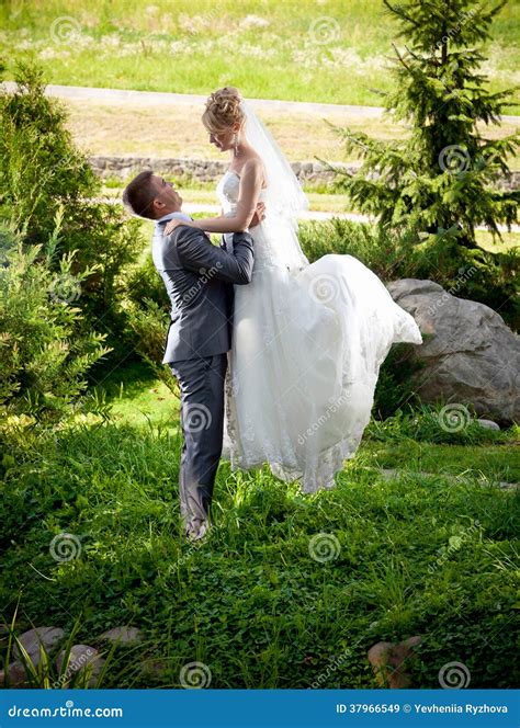 Groom Lifting Up High Beautiful Bride At Park Stock Image Image Of