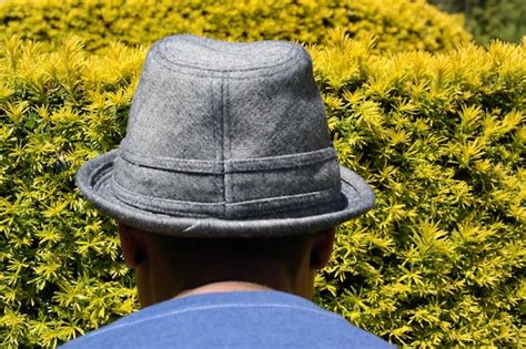 Premium Photo Rear View Of Man Wearing Cap On Field