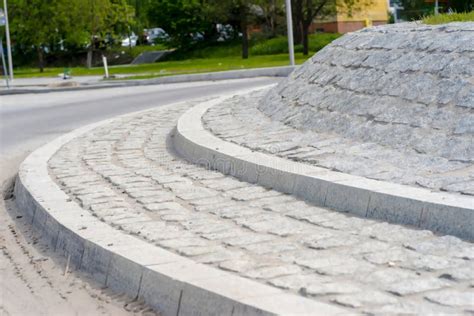 An Island On A Newly Built Roundabout Made Of Granite Paving Stones