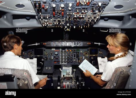 Male Pilot And Female Co Pilot In The Cockpit Of A Boing 737 Commercial