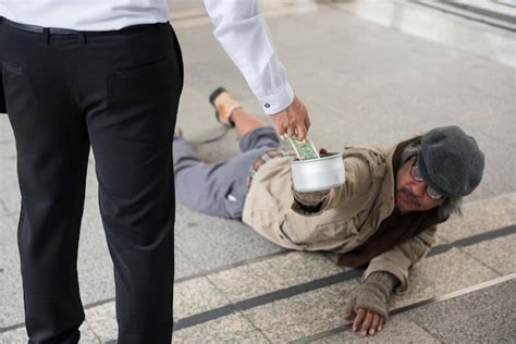 Premium Photo Midsection Of Man Giving Money To Beggar In Footbridge