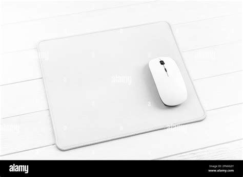 Computer mouse on white mouse pad Stock Photo - Alamy