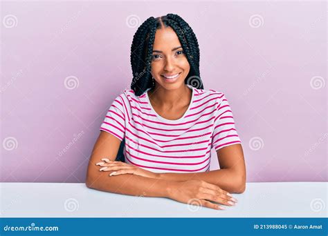 Beautiful Hispanic Woman Wearing Casual Clothes Sitting On The Table