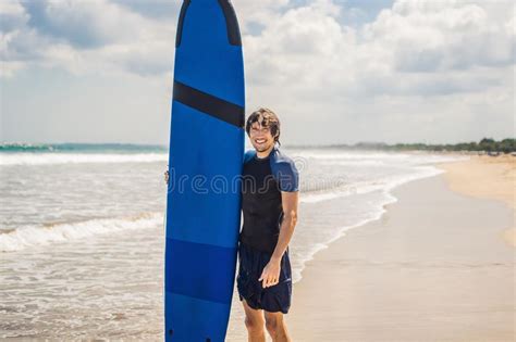 Man Carrying Surfboard Over His Head Close Up Of Handsome Guy With