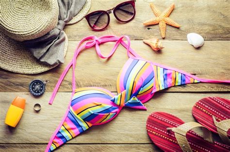 Premium Photo Beauty Colorful Bikini And Accessories On Wooden Floor