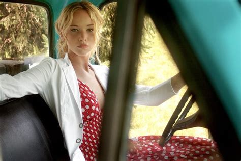 Woman In Red And White Polka Dot Dress And White Blazer Sitting Inside