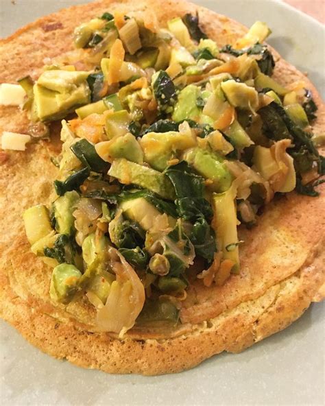 An Omelet With Spinach And Other Vegetables On It