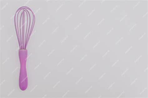 Premium Photo Purple Whisk For The Kitchen On A White Background