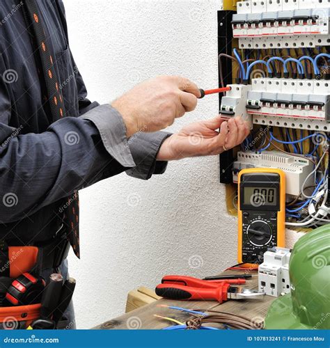 Elegant Electrician Technician At Work On A Residential Electric Stock