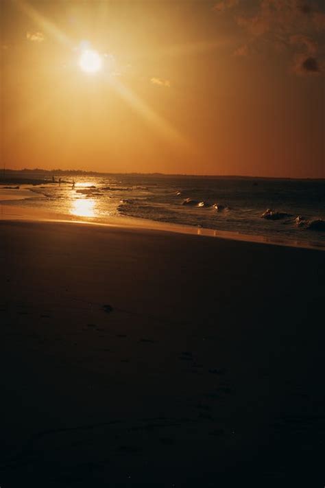 Waves Crashing on Seashore during Sunset · Free Stock Photo