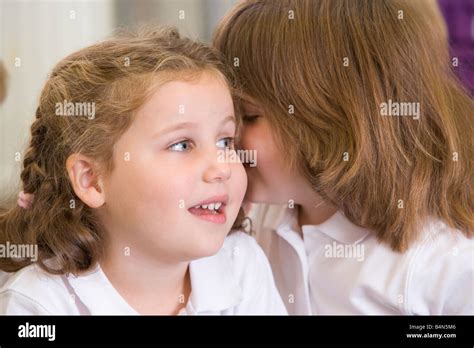 Two Students In Class Whispering Selective Focus Stock Photo Alamy