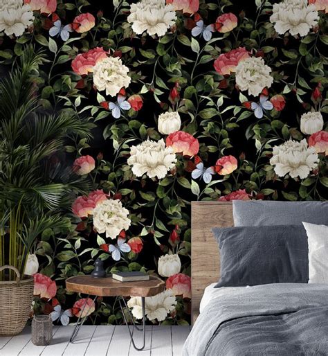 A Bed Sitting Next To A Wall Covered In Flowers And Greenery On Top Of