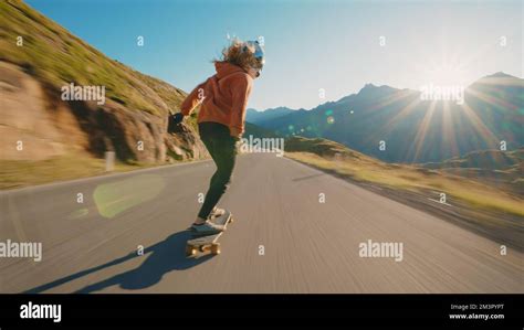 Cinematic downhill longboard session. Young woman skateboarding and ...