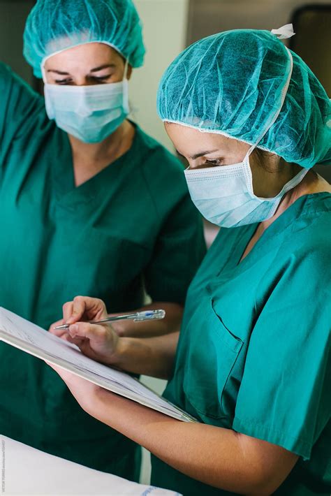 "Surgeons Checking A List In An Operating Room" by Stocksy Contributor