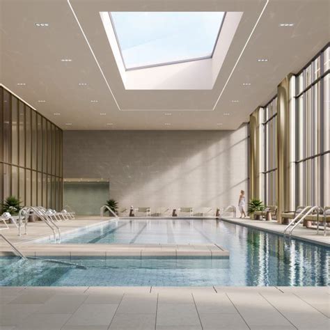 An Indoor Swimming Pool With Skylights And Chairs