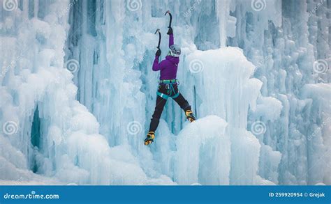 Alpinist Woman With Ice Tools Axe In Orange Helmet Climbing A L Stock