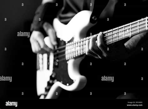 Man S Hands On The Strings Of A Bass Guitar With Shallow Depth Of Field