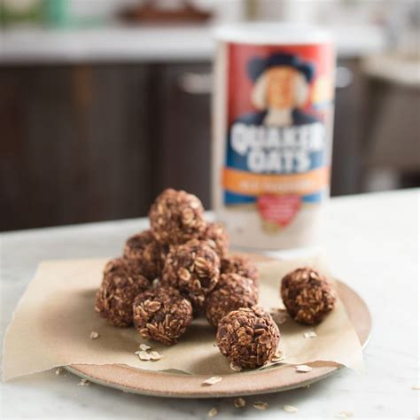 Chocolate Balls Are On A Plate Next To A Can Of Peanut Butter