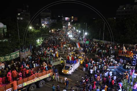 Image Of Ganesh Idols In Trucks And Crowd Of Devotees At Tank Bund For