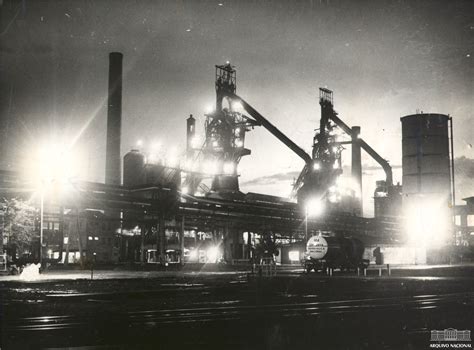 An Old Factory With Lots Of Machinery In The Background At Night Lit