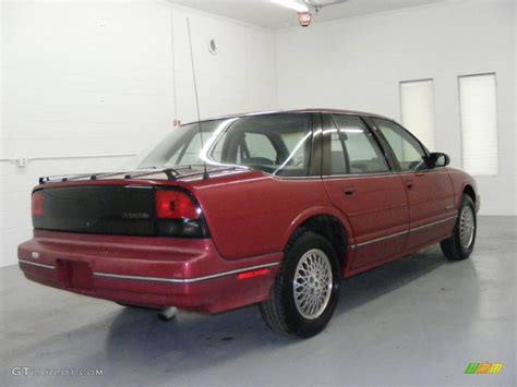 Medium Garnet Red Metallic Oldsmobile Cutlass Supreme Sedan