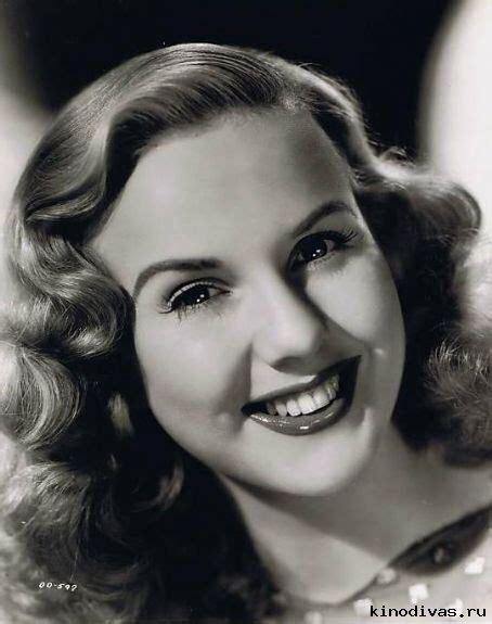 A Black And White Photo Of A Woman Smiling