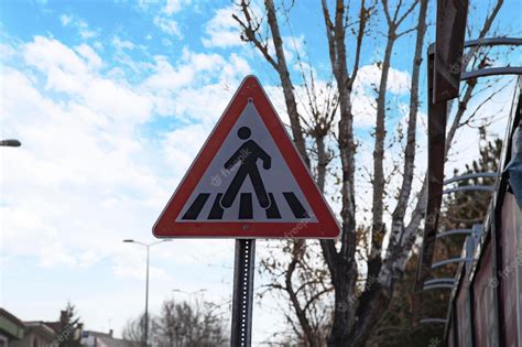 Premium Photo | Red and black pedestrian crossing sign on the sky ...