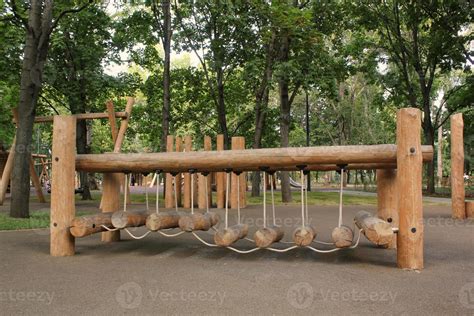 Rope bridge in outdoor modern children wooden playground in a public ...