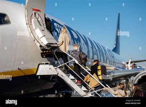 Passengers Stepping Into Ryanair Boeing Airplane At London