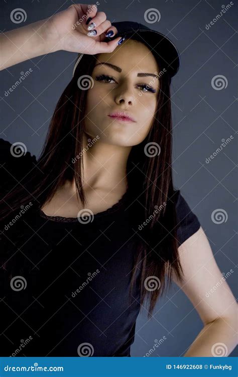 Brunette Girl Holding Her Cap While Posing Studio Stock Photo Image