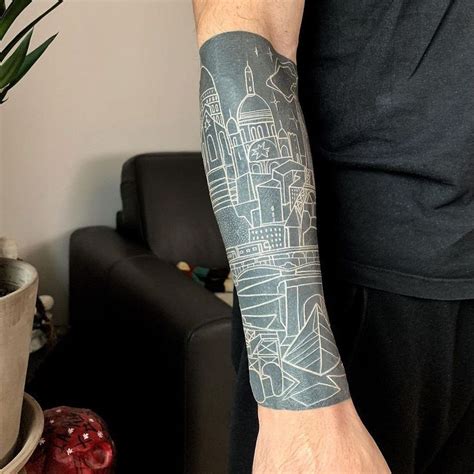 A Man With A Tattoo On His Arm