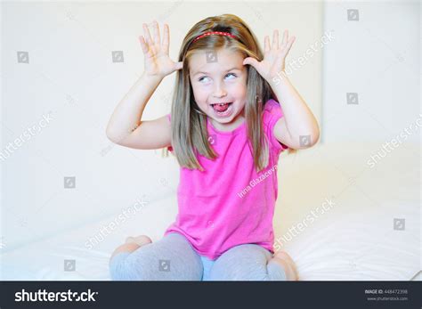 Adorable Little Girl Making Funny Faces Stock Photo 448472398 ...