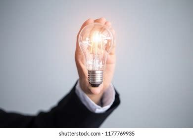 Business Man Holding Light Bulbs Ideas Stock Photo