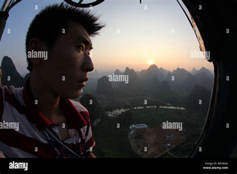 Hot Air Balloon Pilot Flight During Sunset Yangshuo Stock Photo Alamy