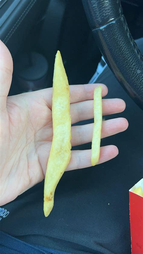 This massive French fry I got from McDonald’s next to a normal sized fry : r/mildlyinteresting