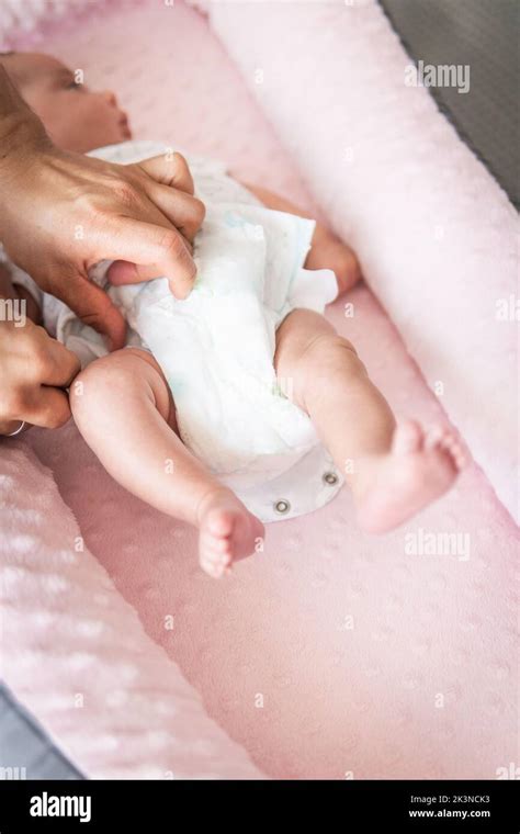 Selective Focus Of Man S Hands Placing The Diaper On A Baby In His Crib