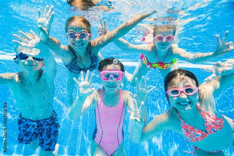 little kids swimming in pool underwater. Stock Photo | Adobe Stock