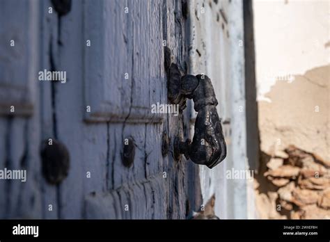 Closeup Side View Of Tthe Knocker Of An Old Blue Painted Wooden Door