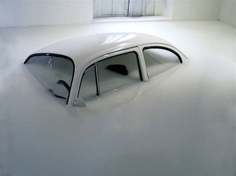 A White Car Is Submerged In Water Inside A Room That Looks Like Its