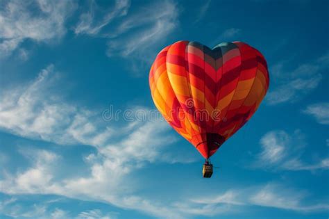 A Heart Shaped Hot Air Balloon Gracefully Floats Through The Sky