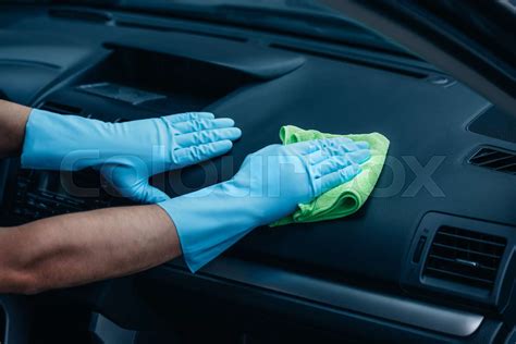 cropped view of car cleaner wiping dashboard with rag | Stock image ...