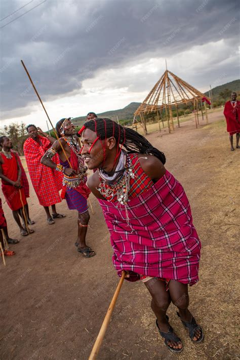 Premium Photo | Masai in traditional colorful clothing showing maasai jumping dance at local ...