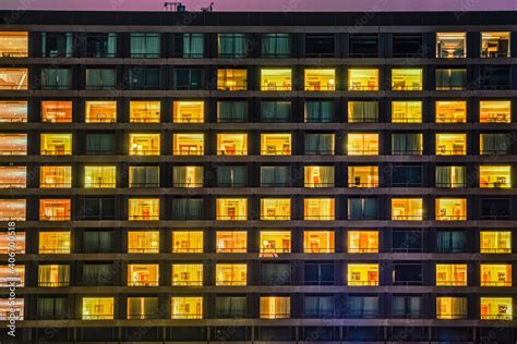 Building Facade Shows A Windows And Rooms Pattern At Night The